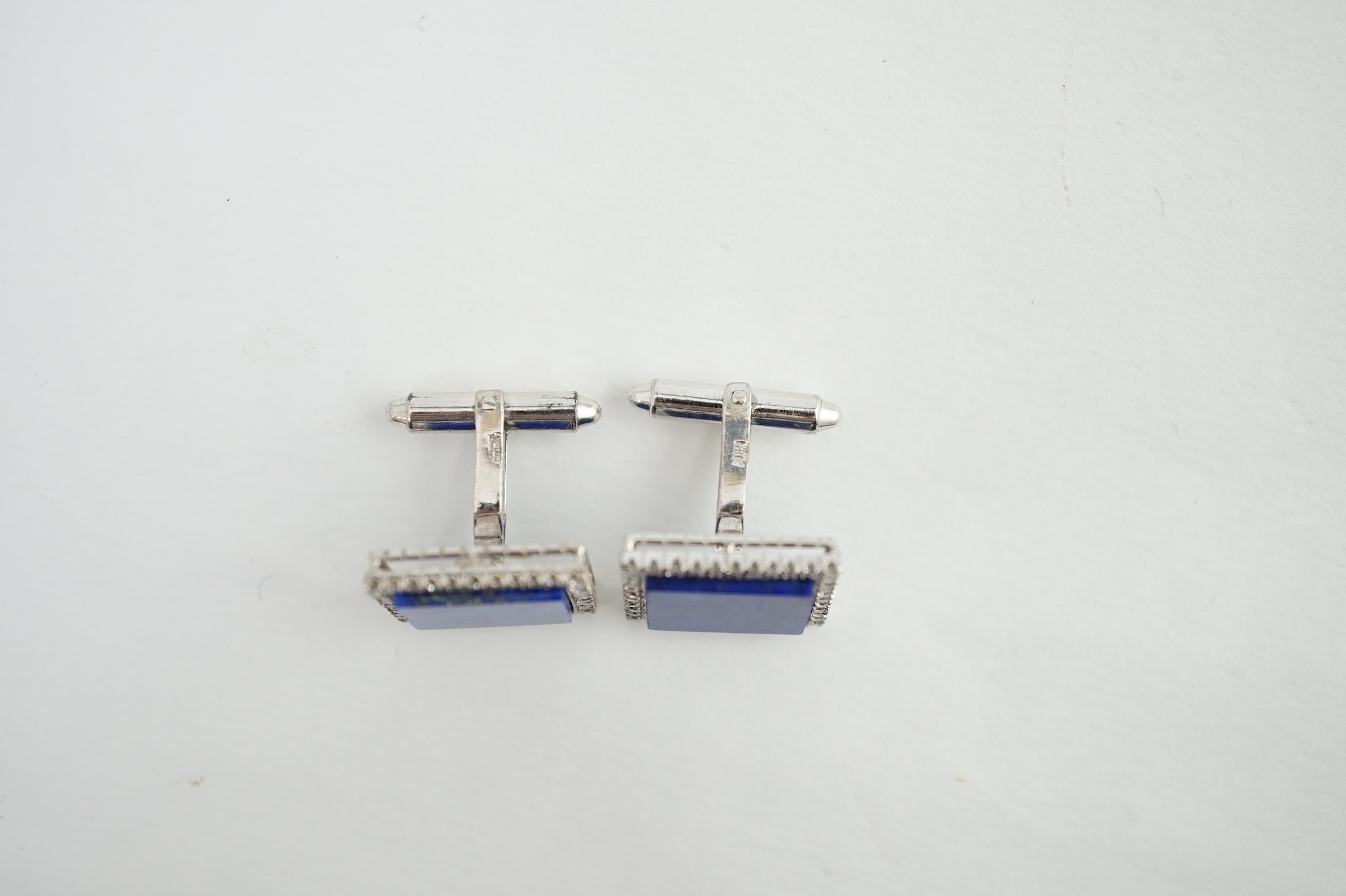 A pair of 18K white gold, lapis lazuli and diamond set tablet cufflinks, each lapis stone surrounded by forty claw set diamonds